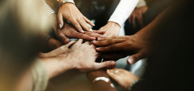 Closeup of diverse people joining their hands